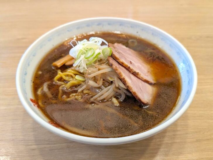 Large slice of chashu pork in soy sauce ramen