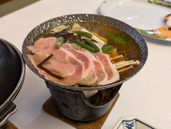 A hearty hot pot featuring Mochi pork and mountain vegetables