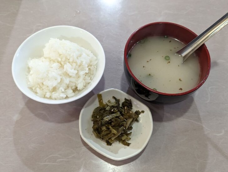 The set includes rice, pickles, and a rich tonkotsu-style soup