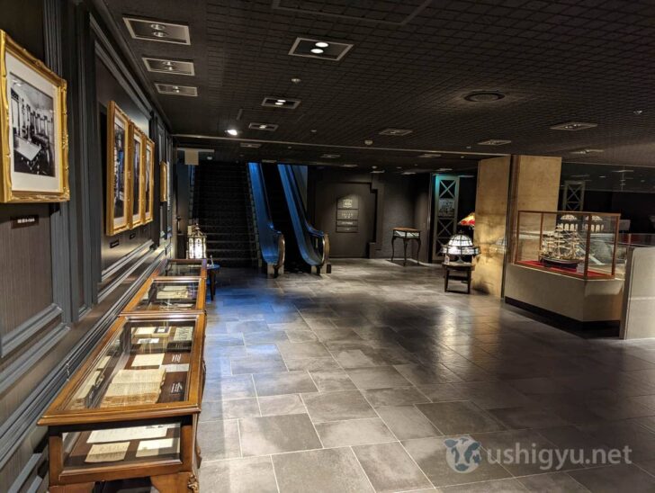 Displays of old dishes, signs, and photos from author Osamu Dazai's visit