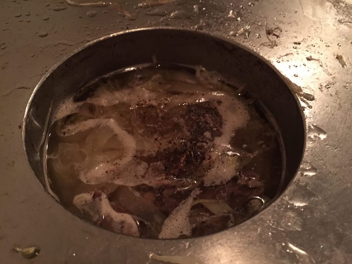 Hand-beaten flat noodles absorbing the flavorful soup