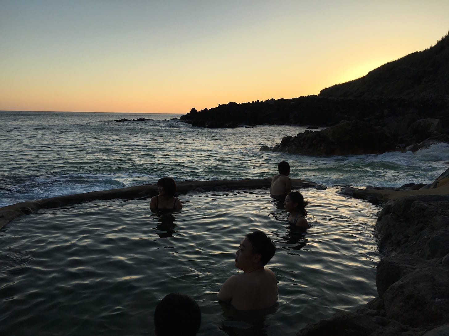 Hot spring with ocean view at sunset