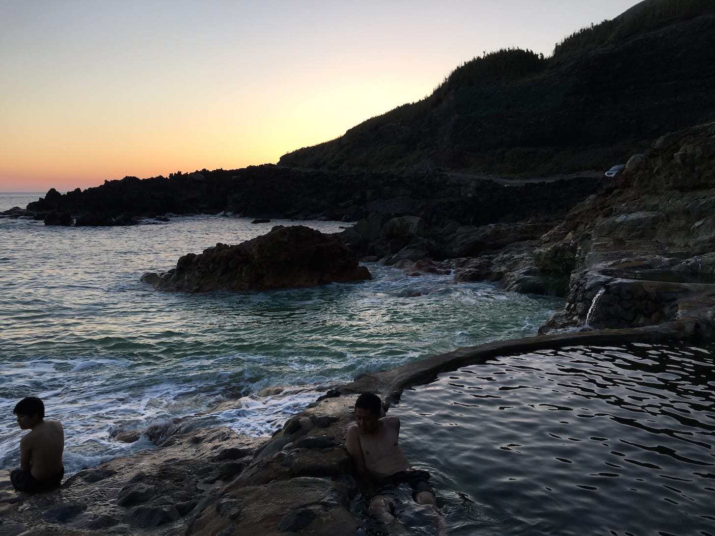 Natural hot spring pool during golden hour