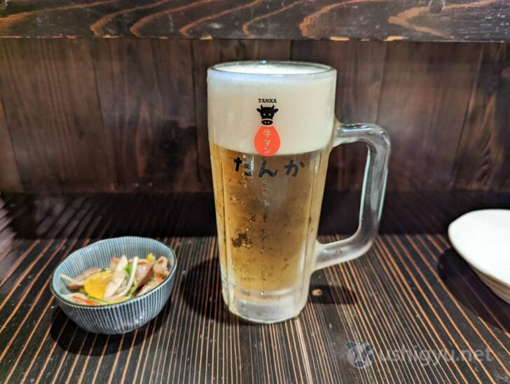 Beer served in Tanca's original mug with a cow with a big tongue printed on it