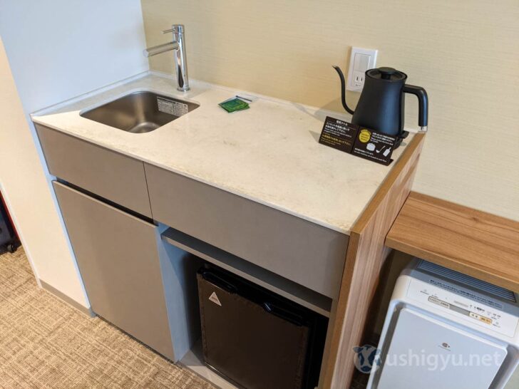 There's a refrigerator, a BALMUDA kettle, and a surprisingly convenient space next to the sink