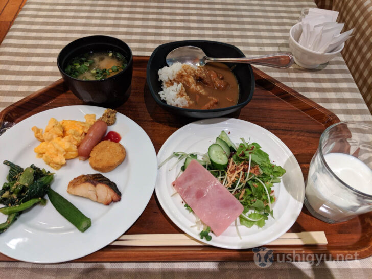 Breakfast buffet with salad, ham, sausage, and curry