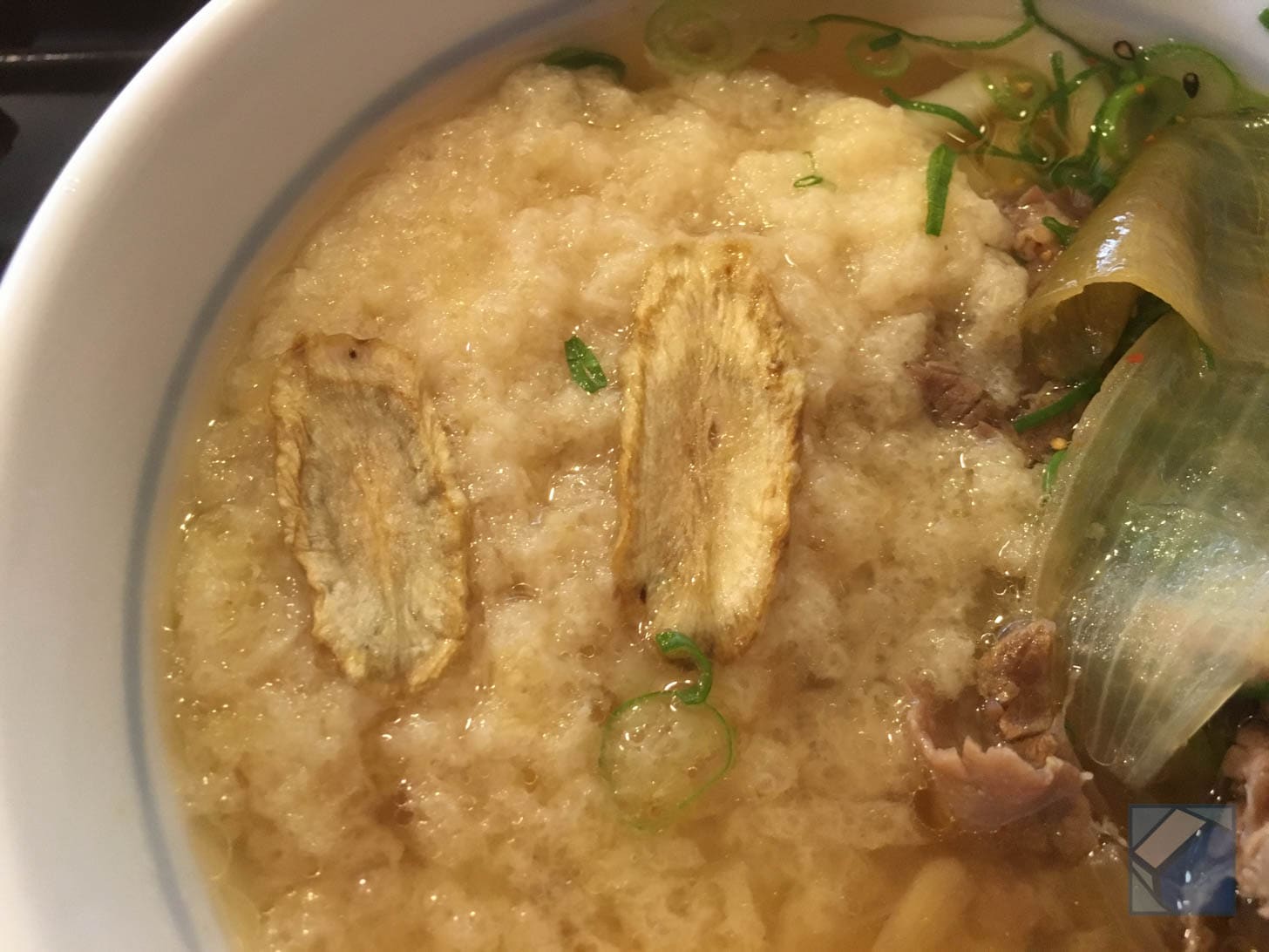Broth-soaked gobō-ten melting into noodles