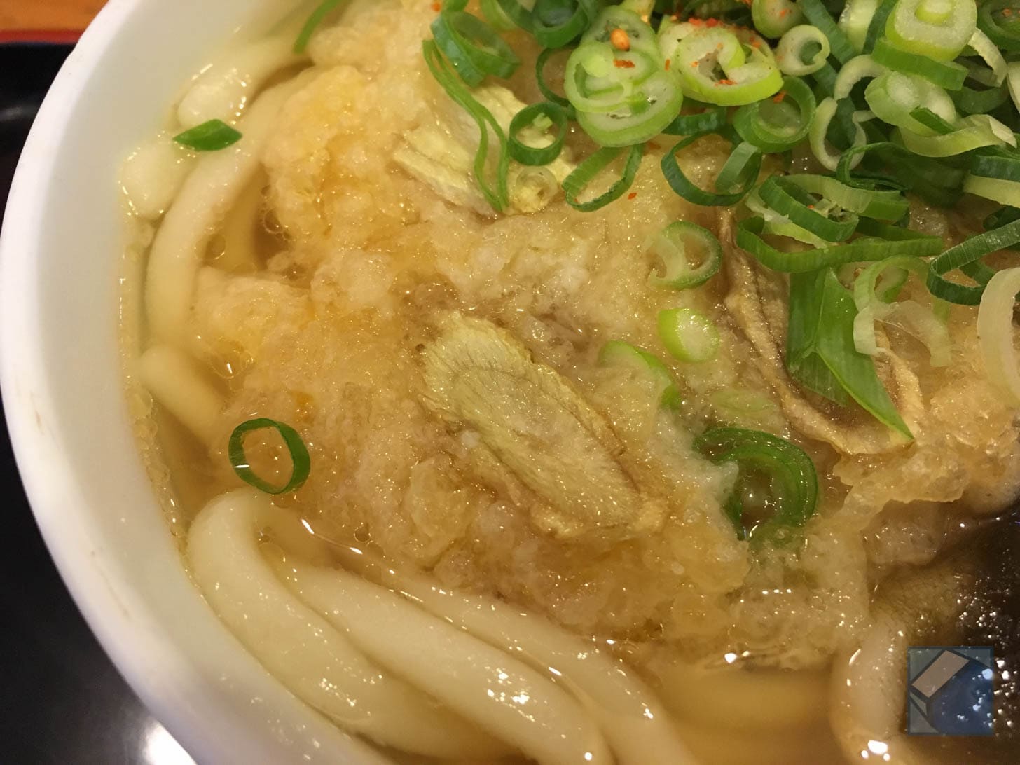 Broth-soaked gobō-ten on konbu udon
