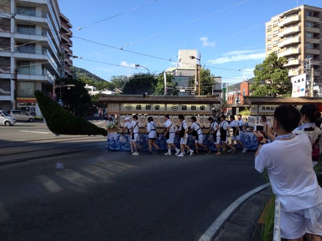 Early evening procession with boats on city streets