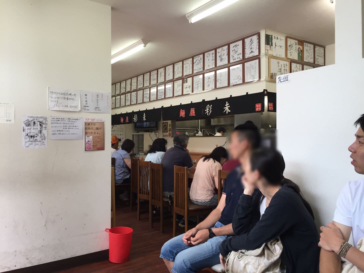 Restaurant interior with celebrity autographs and diners