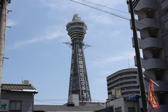Tsutenkaku Tower visible between buildings