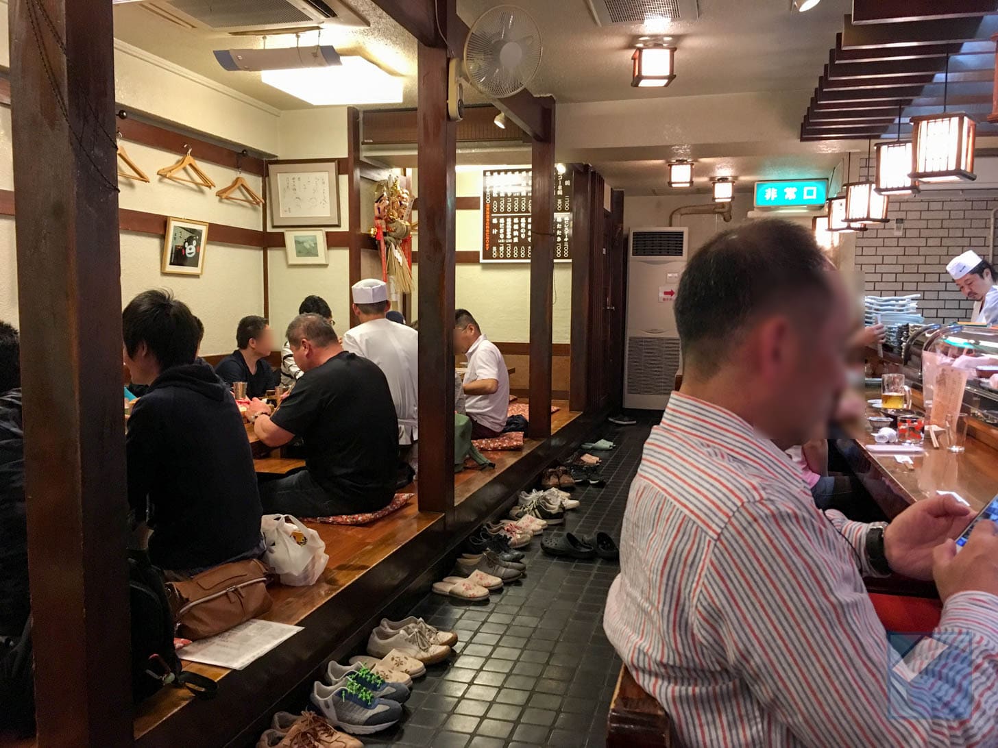 Crowded restaurant interior with customers at tables