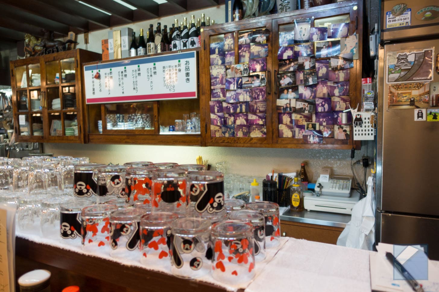 Wall display with photos and Kumamon character glasses