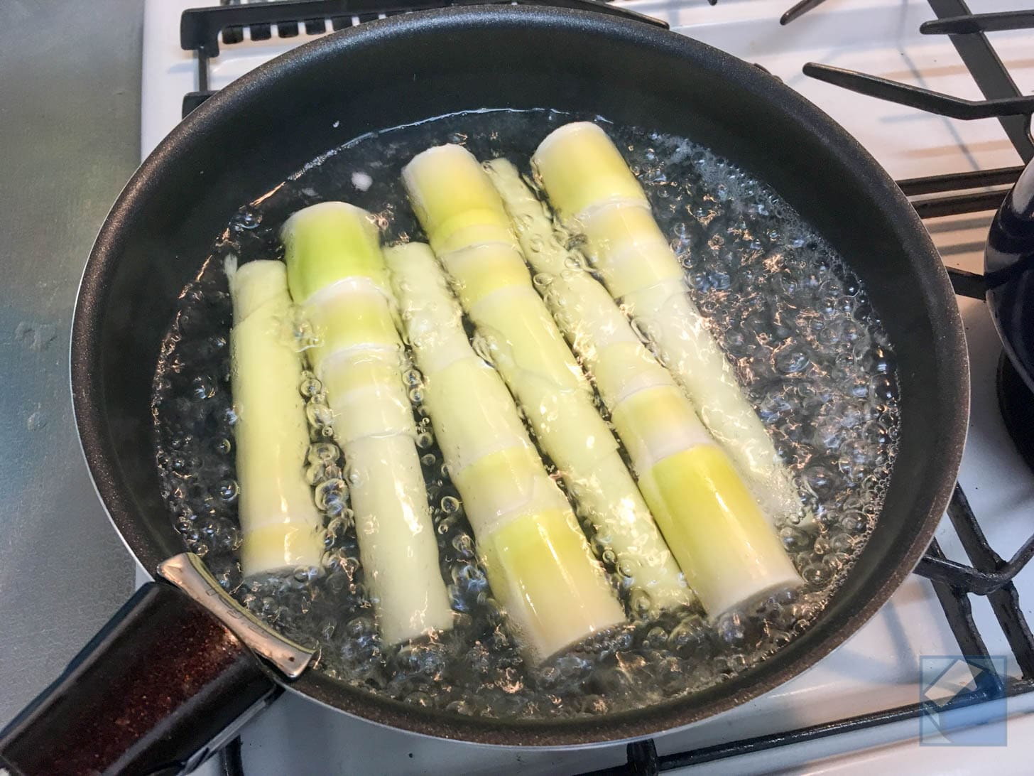Boiling daimyo takenoko in salted water