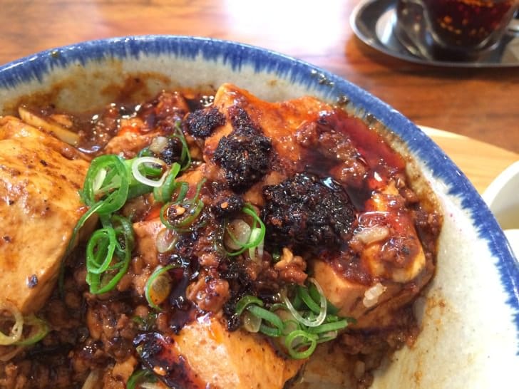 Adding extra chili oil to the dish