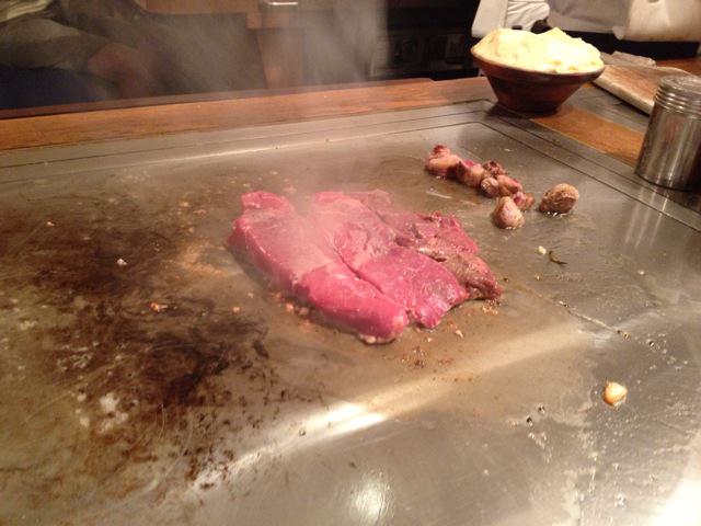 Meat sizzling on hot griddle