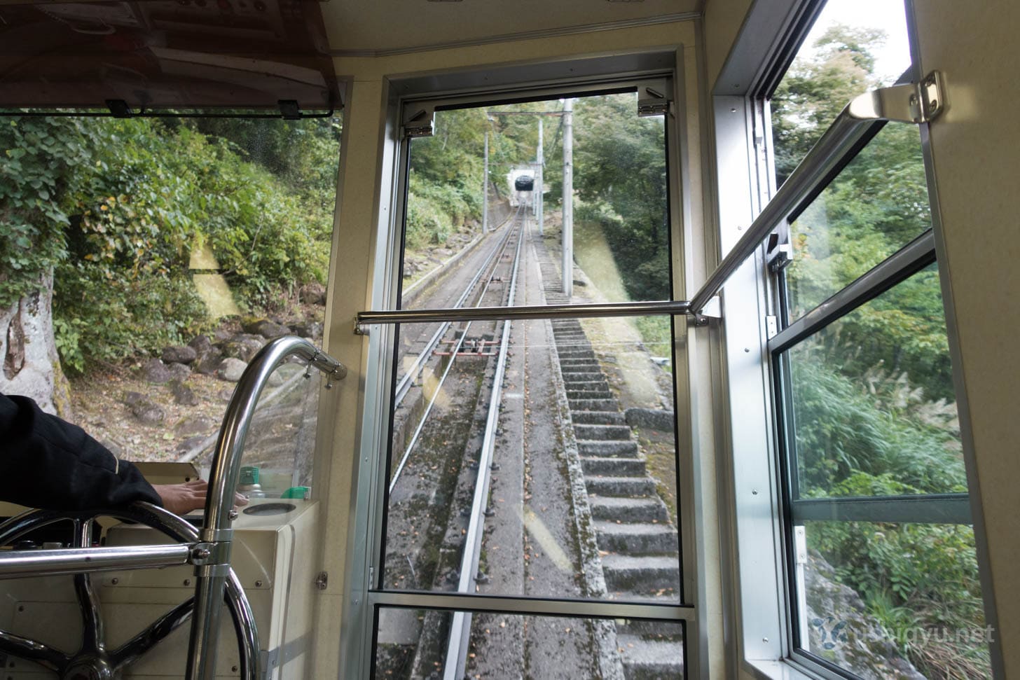 Cable car ascending steep mountain slope