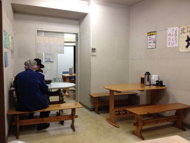 Table seats in the back with elderly couple dining